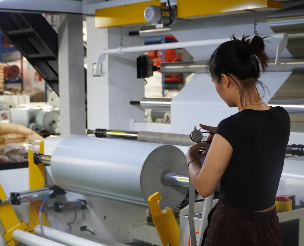 Operator running a film rewinding machine