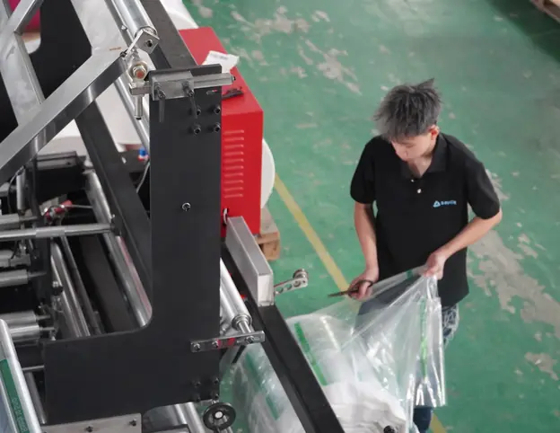 Worker checking film rolls