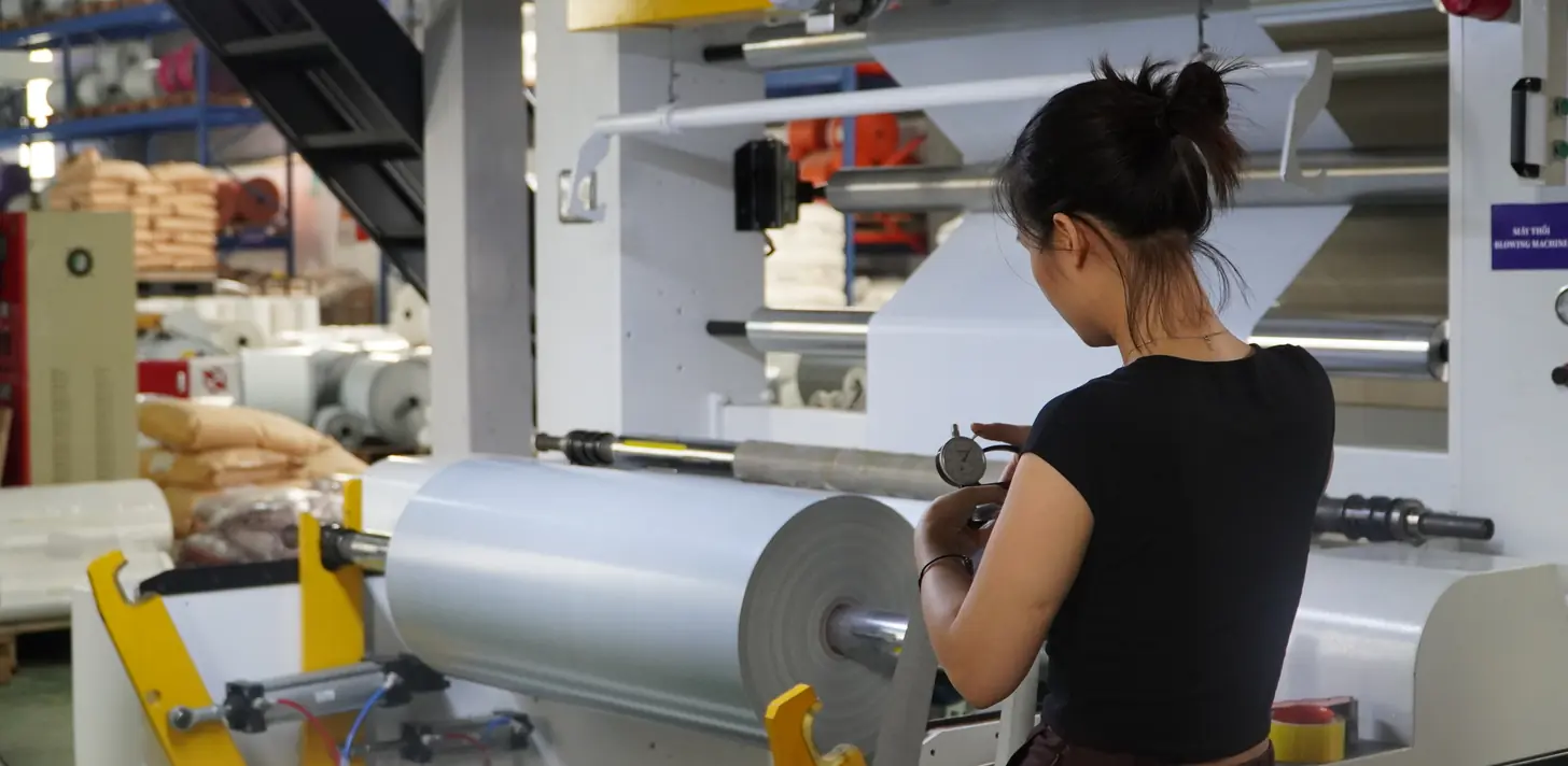 Operator running a film rewinding machine